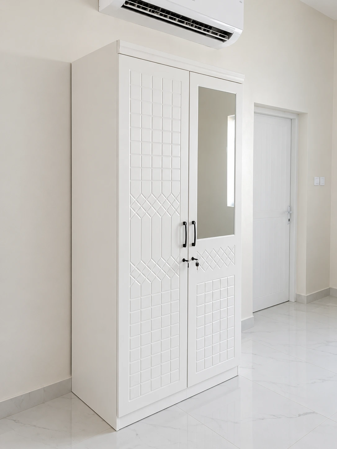 White two-door wardrobe with mirror installed at Yanqul camp